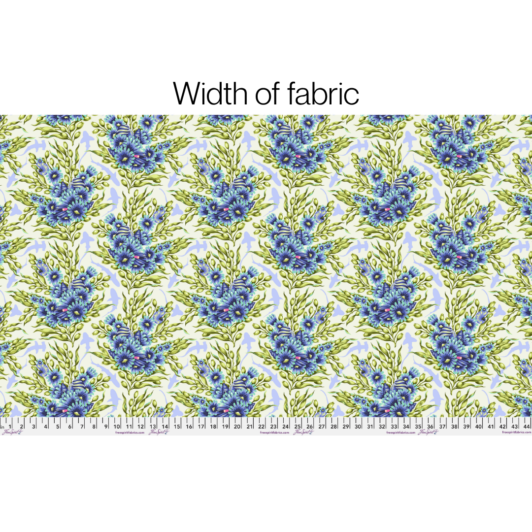 Fabric with blue floral pattern and a ruler at the bottom for measurement.