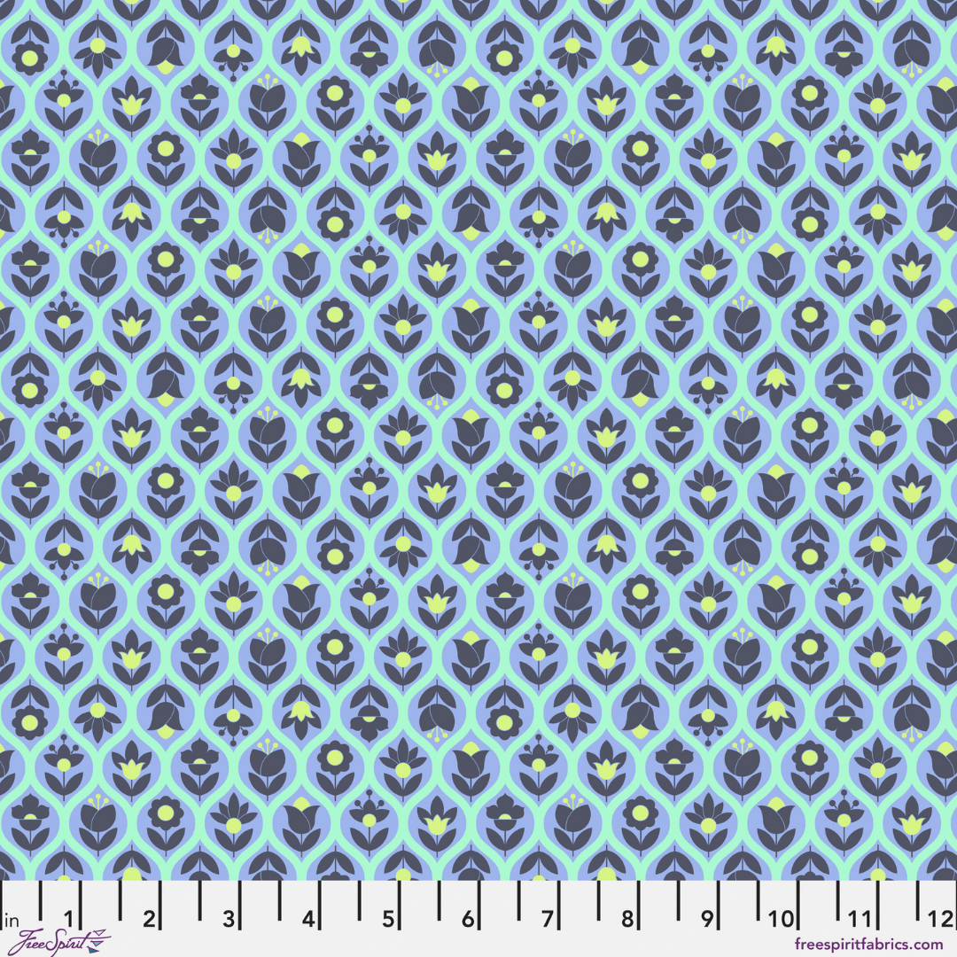 Patterned fabric with blue and green design on a light blue background