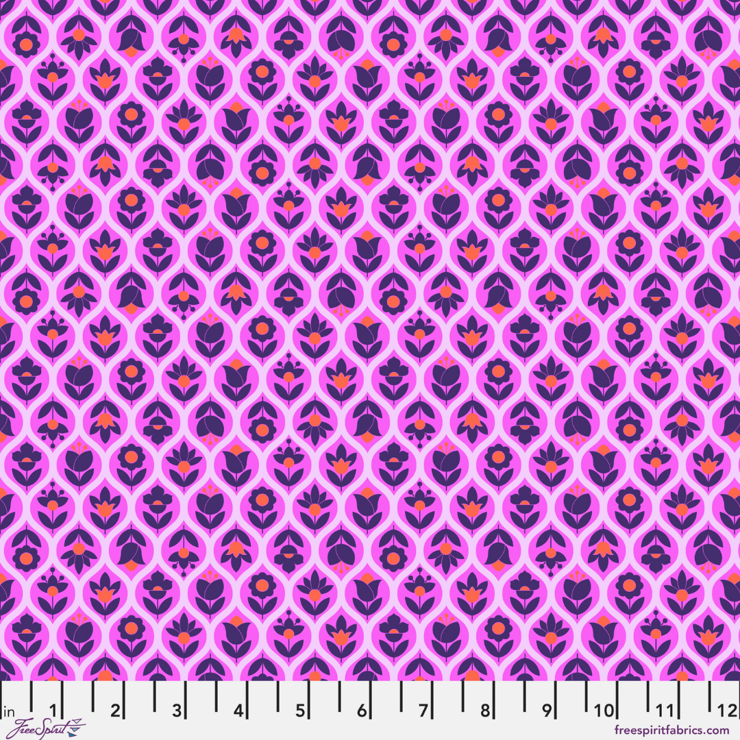 a bold little floral print with dark purple blooms tucked inside a bright pink trellis design with a ruler at the bottom
