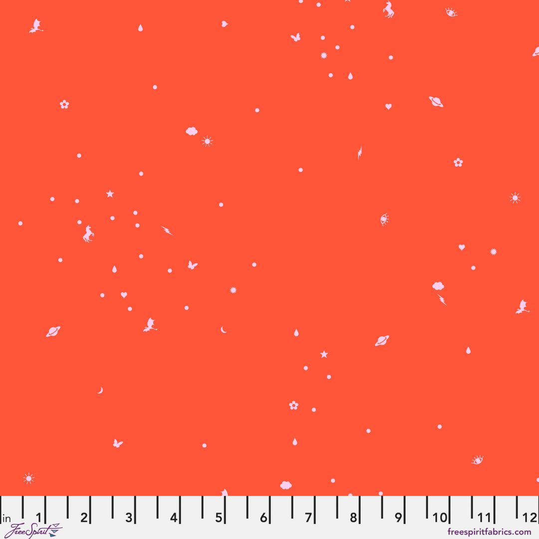 Fabric swatch with a tiny tossed print filled with little magical icons on a bright coral-orange background with a ruler at the bottom
