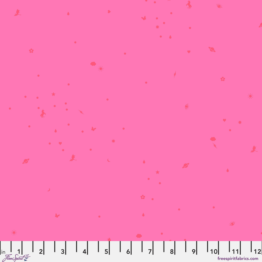 Pink fabric with small red floral patterns and a ruler at the bottom.