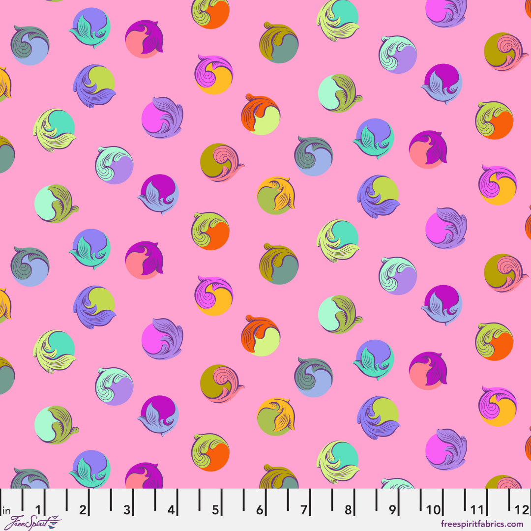Colorful polka dots with leaf designs on a pink ground with ruler at bottom