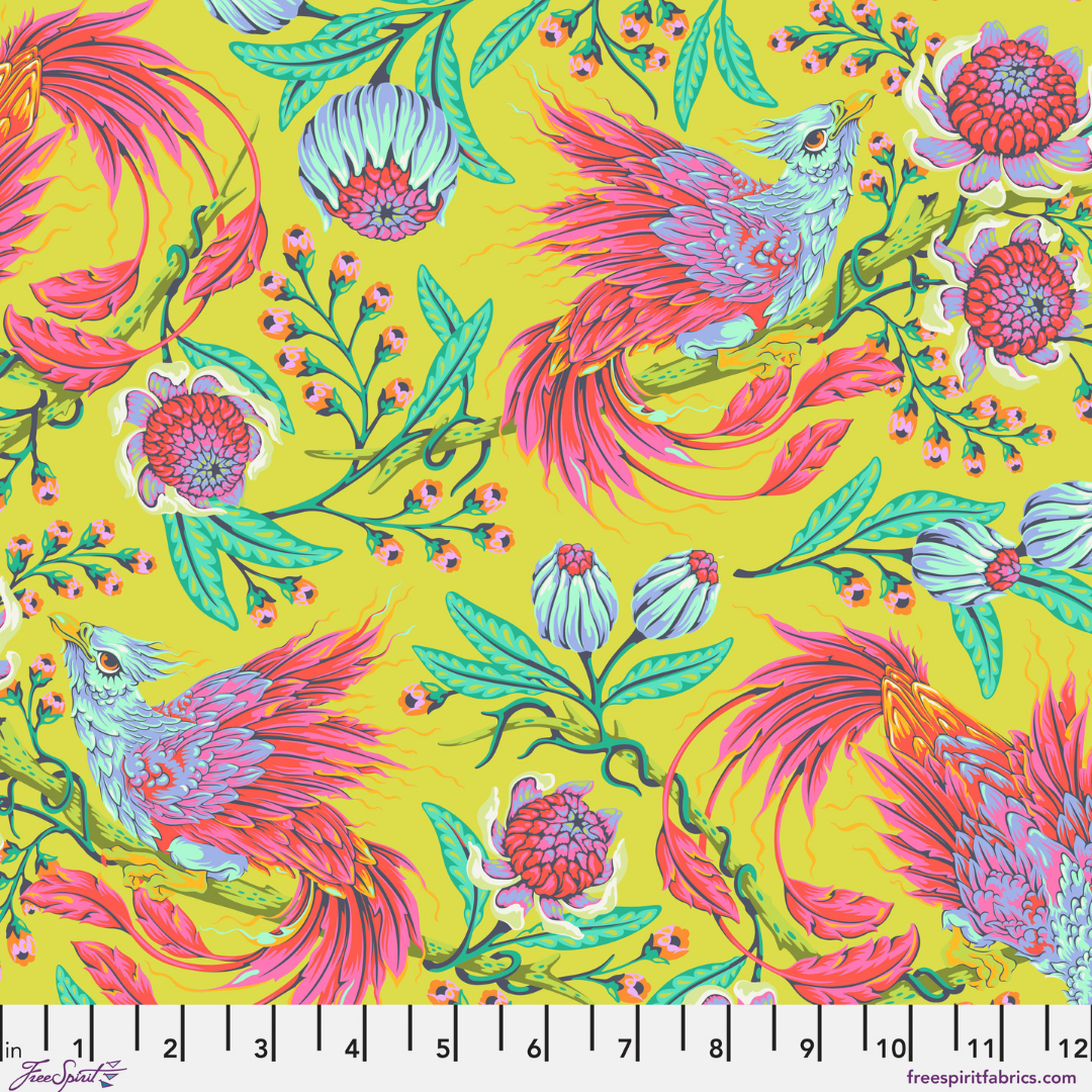 Fabric Swatch with a glorious phoenix print with sweeping pink and coral wings, aqua details, leafy vines, and bold fantasy florals on a bright apple-green background. It is dramatic, colorful, and very much ready to be the main character.  Has a ruler at the bottom.