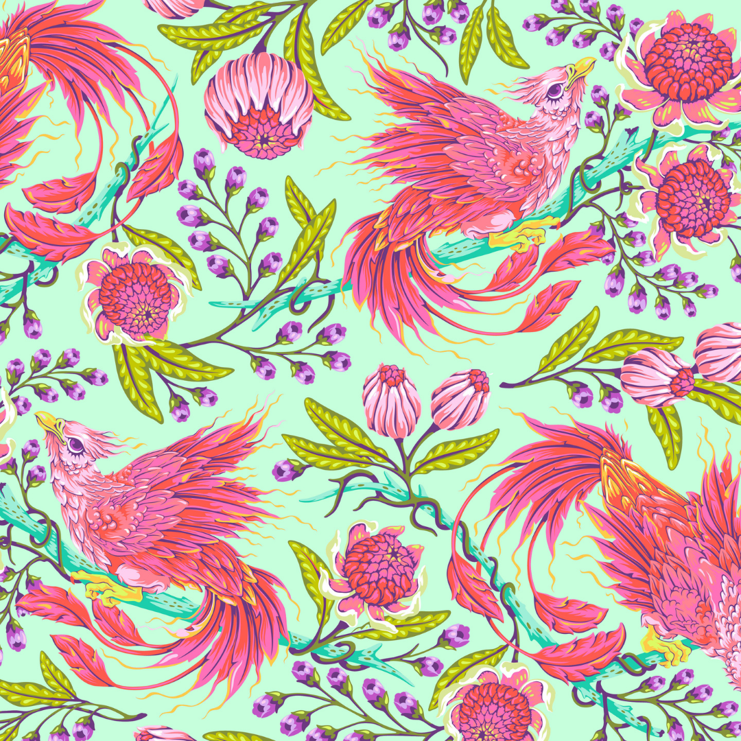 pink and coral phoenix-style birds with swooping tails, bright florals, leafy greens, and little purple pops on a soft minty Stardust background. It is bold, magical, and a little extra, which is exactly the point.