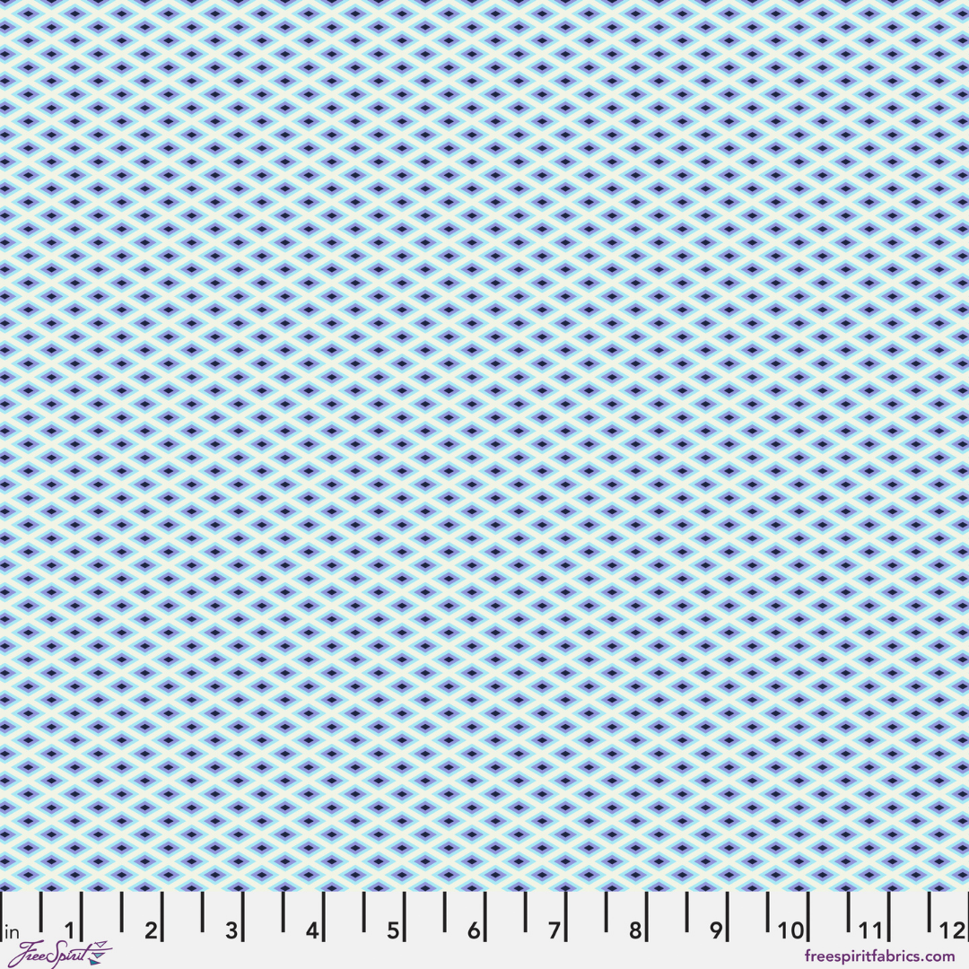 fabric swatch with a Pattern of small blue diamonds on a white background with ruler at the bottom