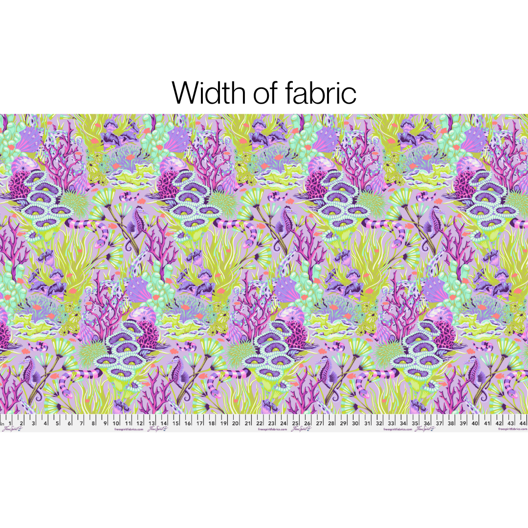 Fabric with a colorful coral pattern and a ruler at the bottom for scale.