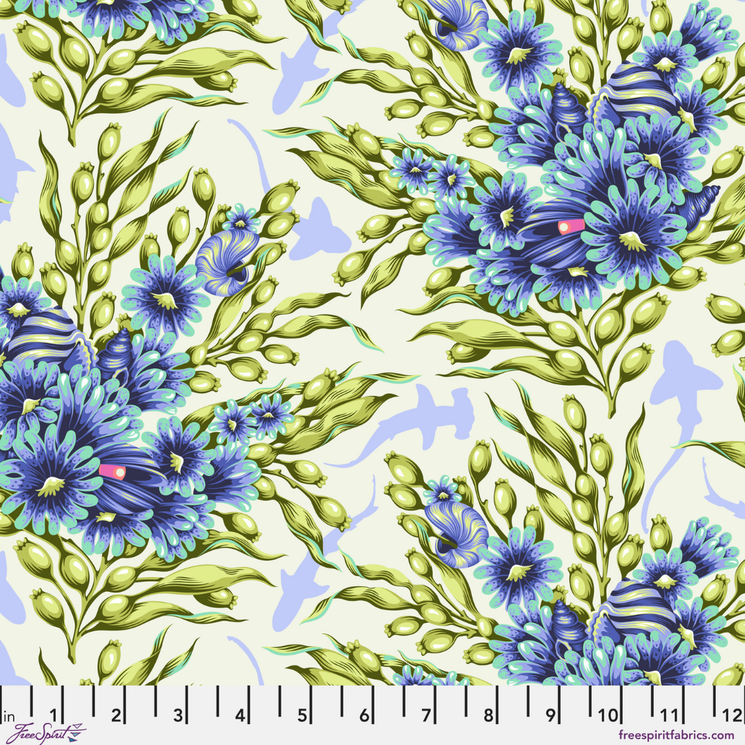 Pattern of blue flowers and green leaves on a white background with a ruler at the bottom.