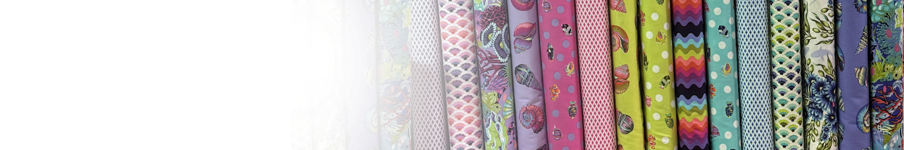Collection of colorful fabric strips with various patterns on a white background